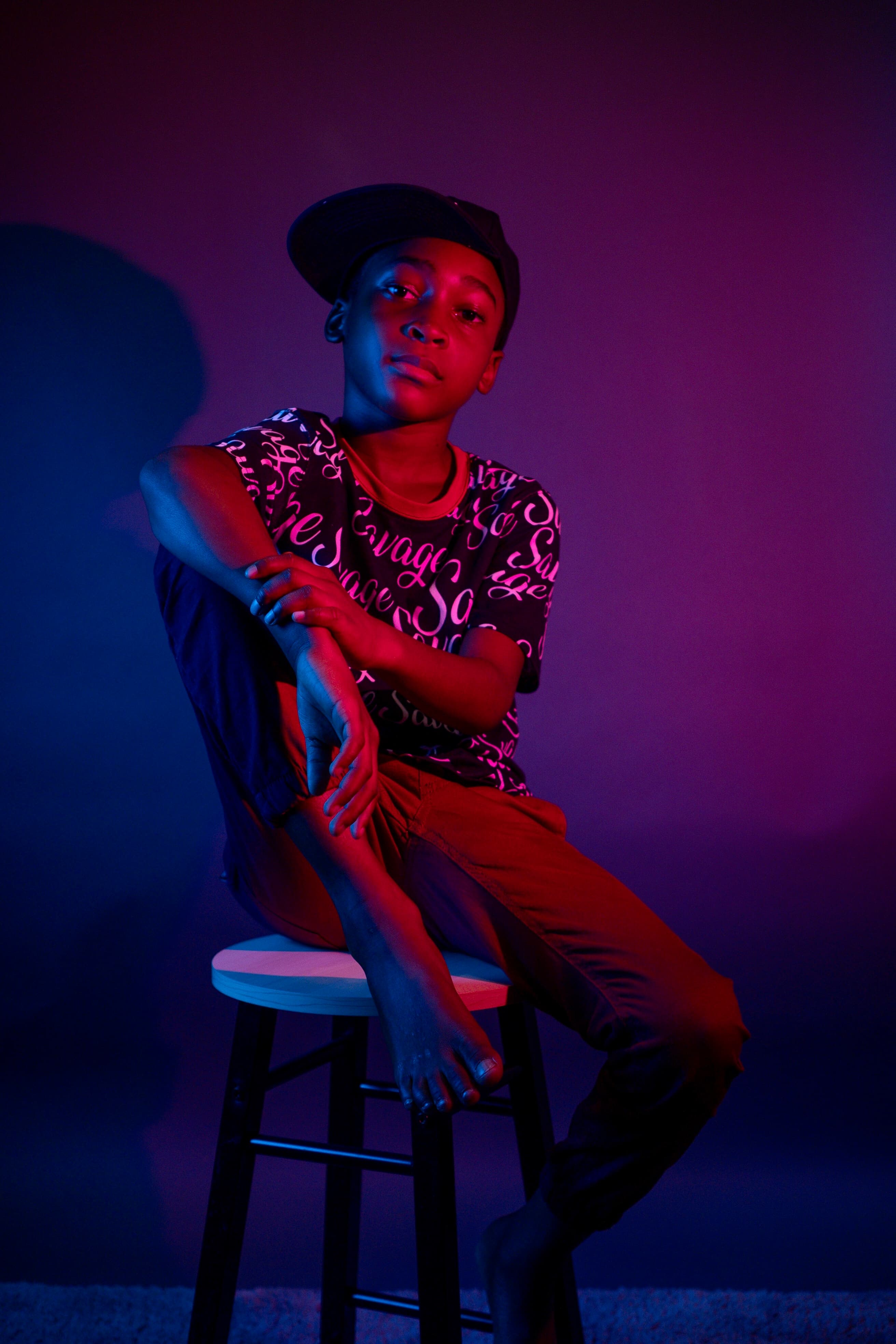 Portrait, young boy under neon purple and blue lighting