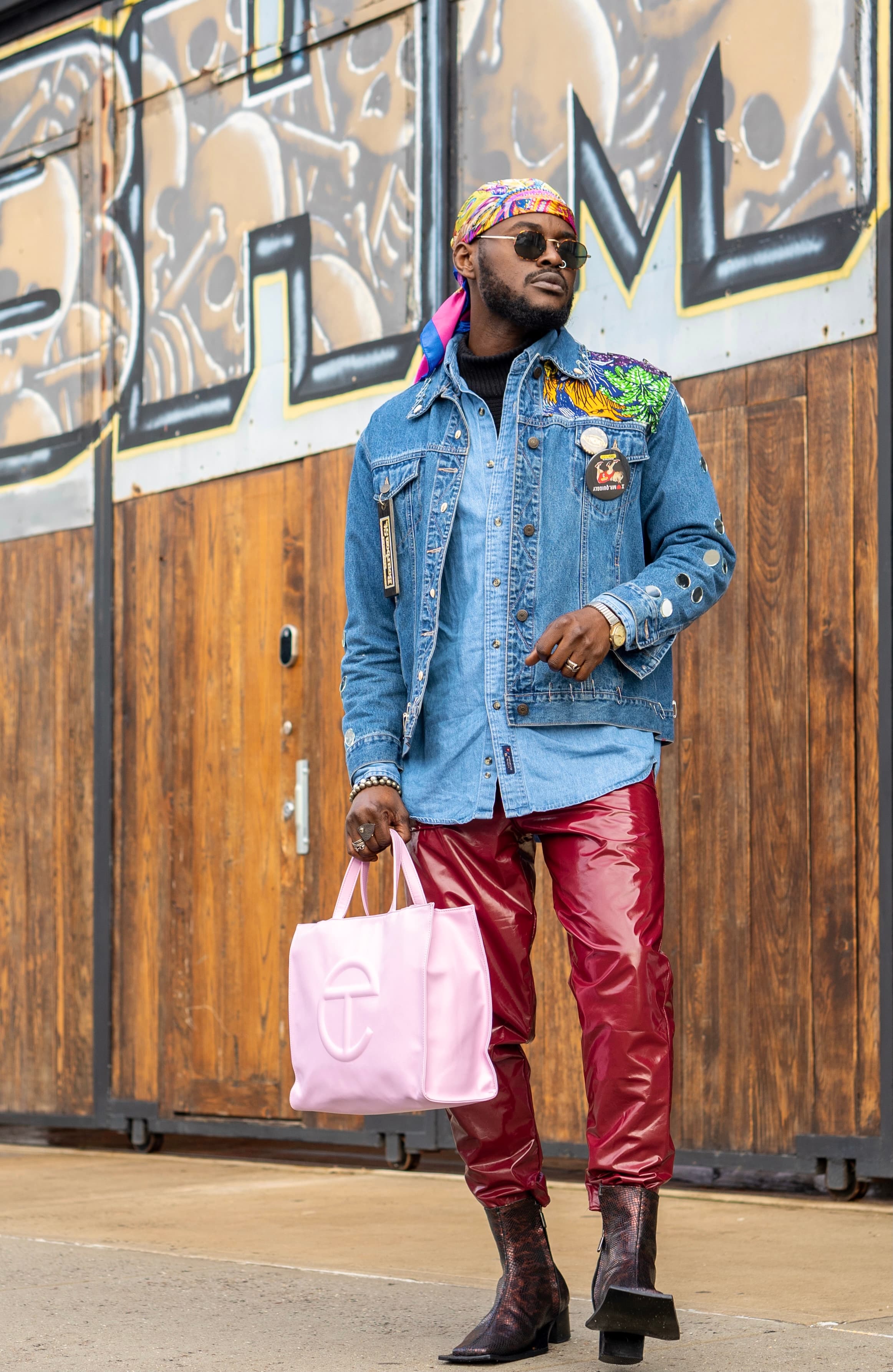 Bold street editorial, man in denim jacket, red leather trousers