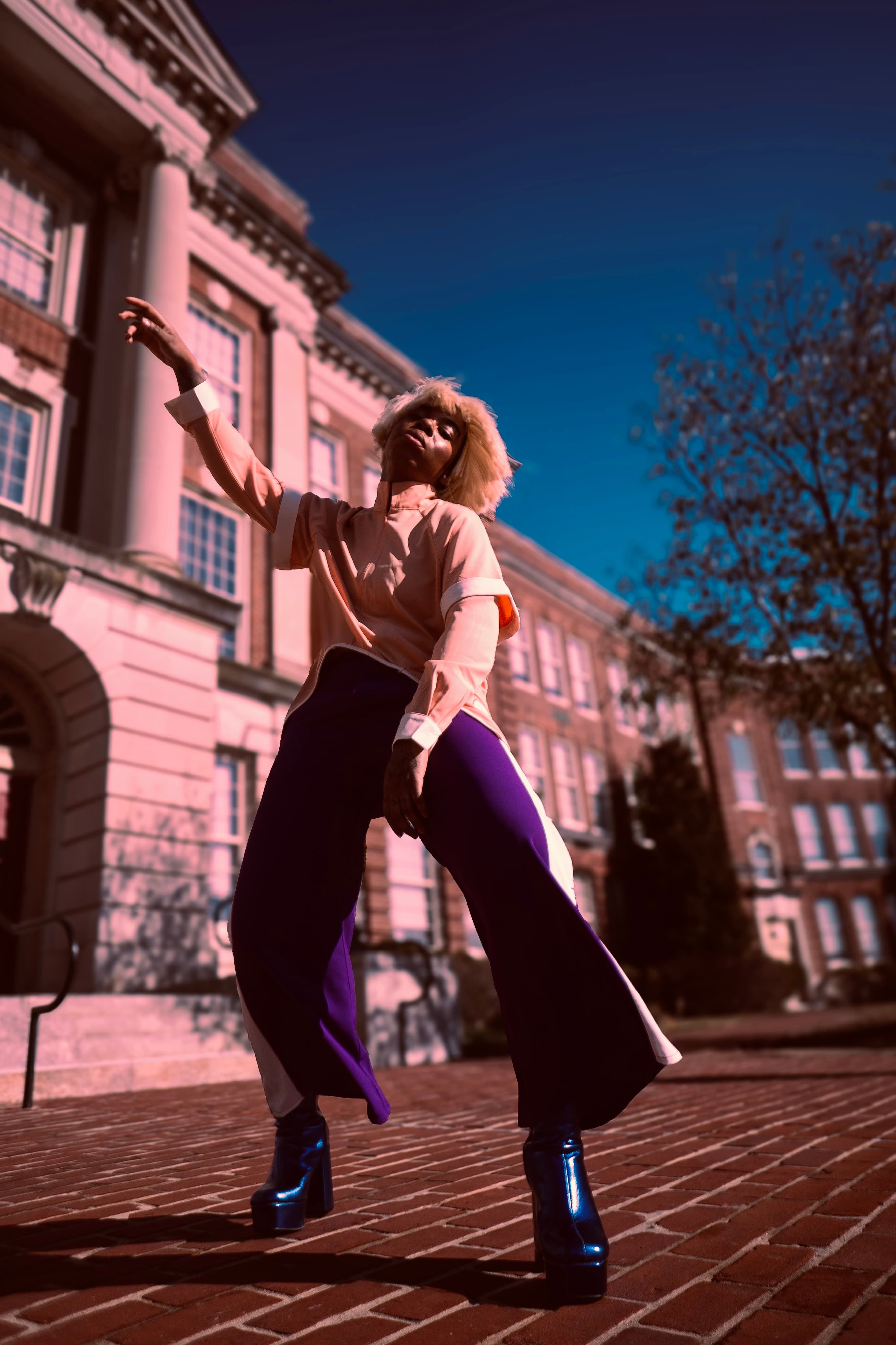 Editorial, woman in pink blazer against neoclassical building