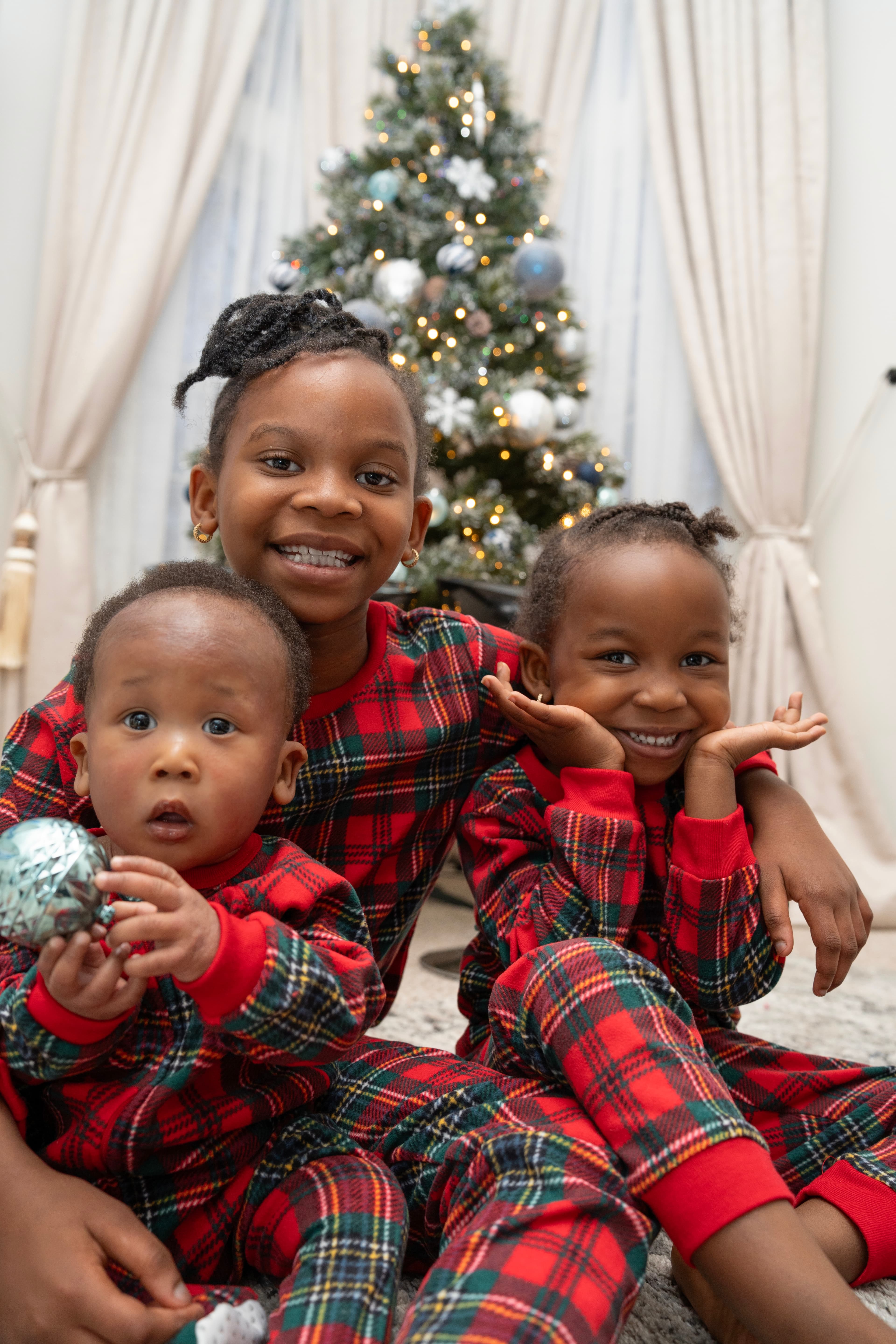 Children Christmas portrait, three siblings in matching pajamas